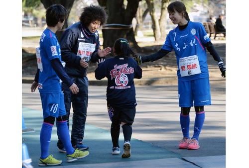 小学生を出迎える3選手の写真